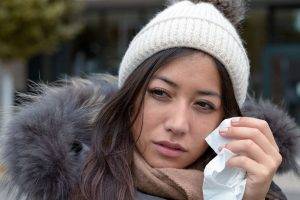 woman wiping her eyes with a tissue